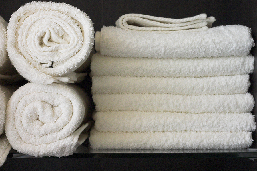 Photo of white towels stacked neatly