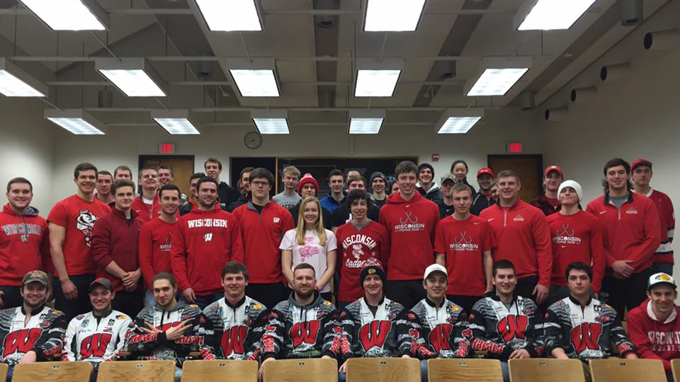 Photo of the UW Fishing team standing together wearing Wisconsin apparel