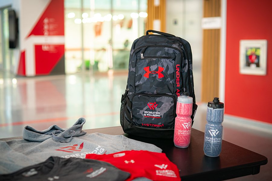 A photo of Rec Well apparel include water bottles, shirts, and a backpack