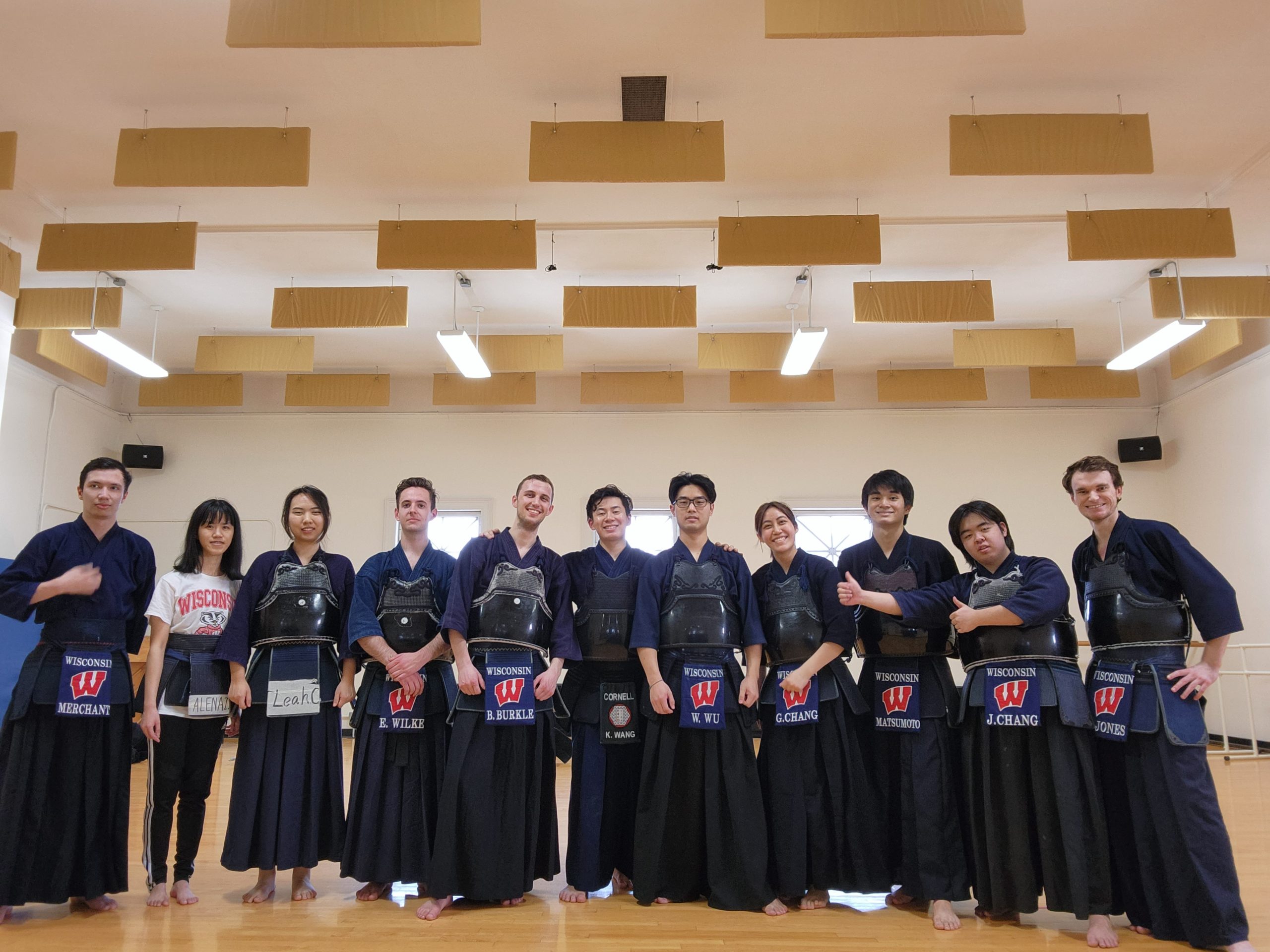 Photo of the UW Kendo team standing together in matching uniforms in an indoor gym