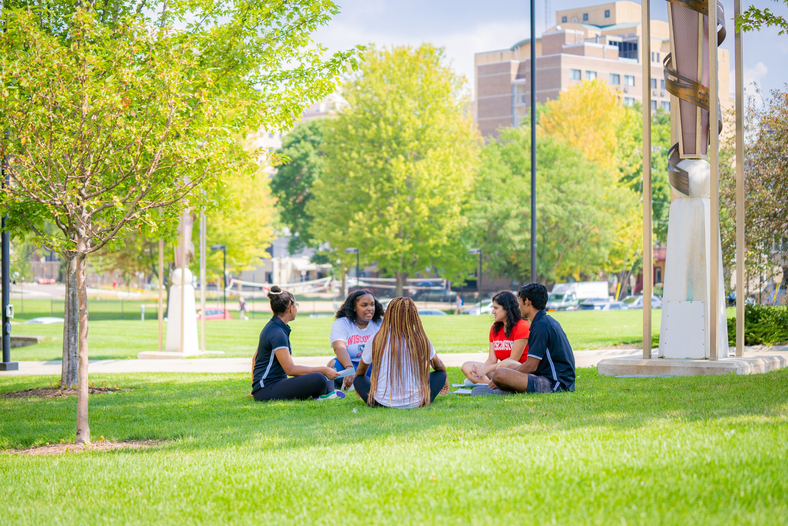 A photo of students sitting outside.