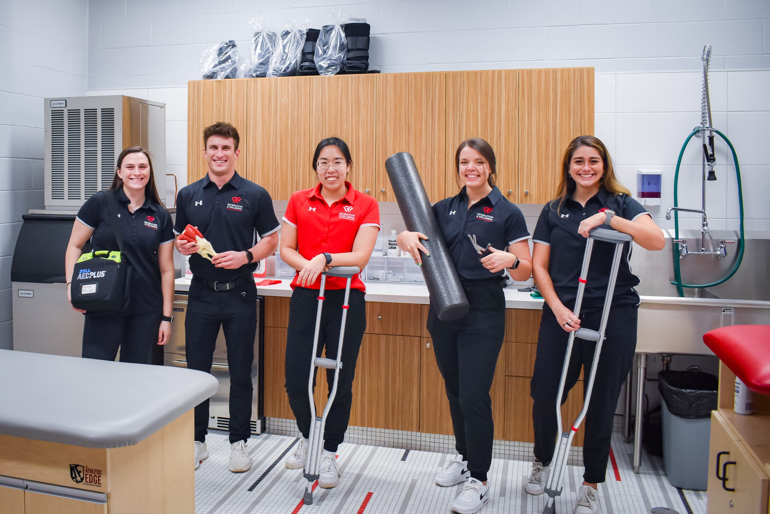 Group of affiliate athletic trainers in AT room.