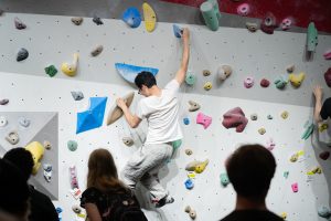 Student using the bouldering wall at Mt. Mendota within the Bakke Recreation and Wellbeing Center.