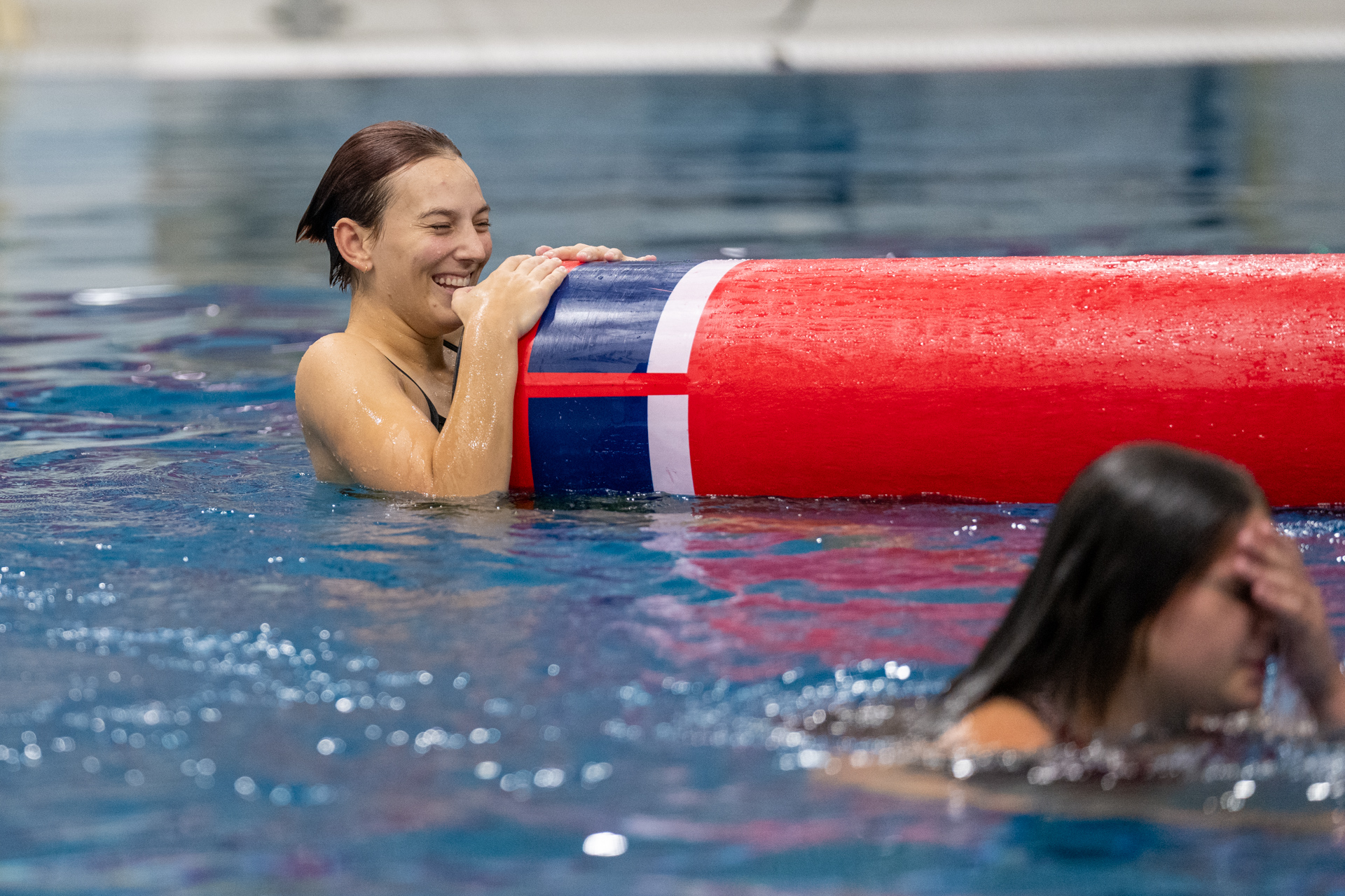 A swimmer is pictured holding the log rolling log.