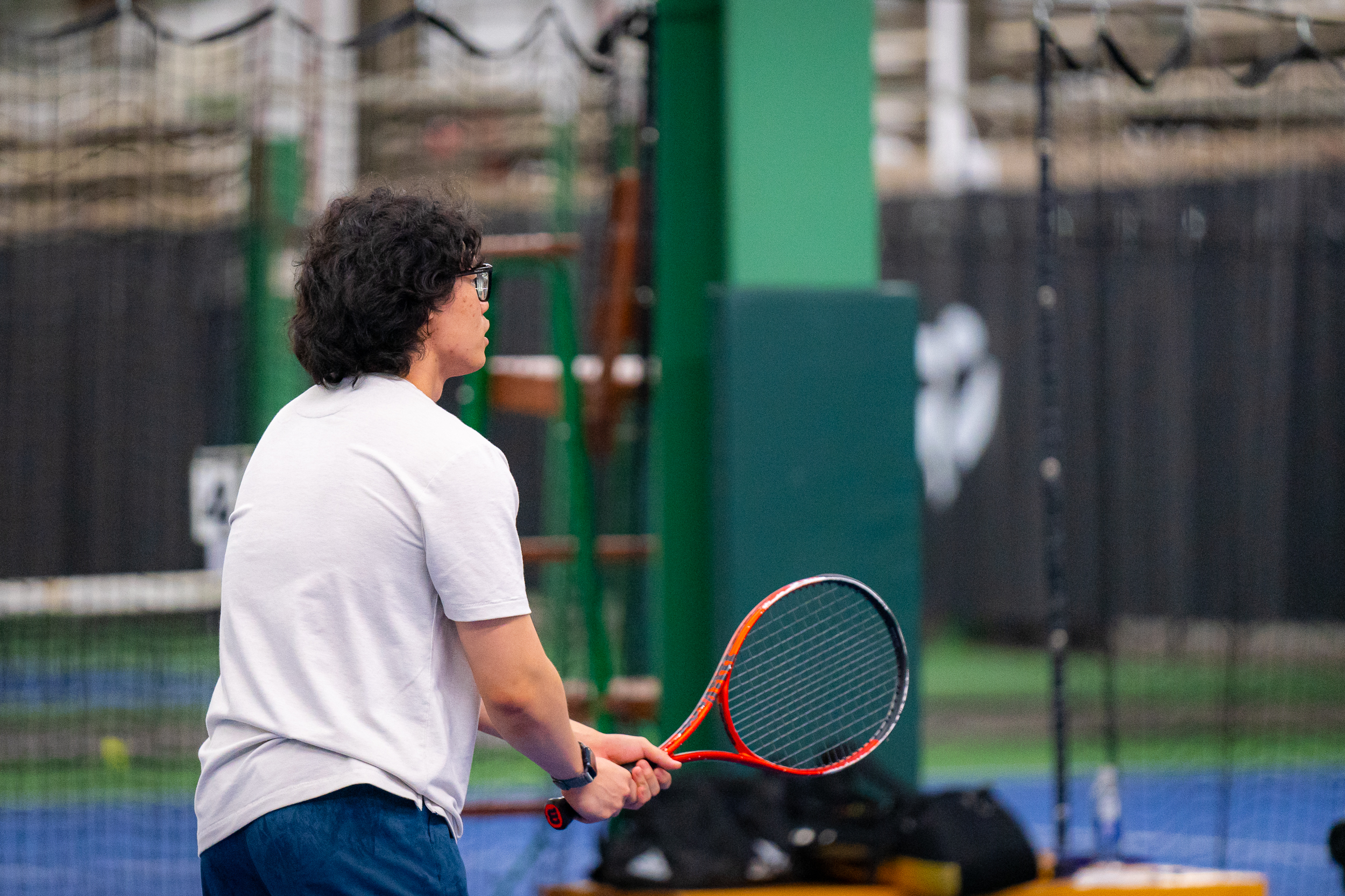 Member waiting to receive a tennis ball.