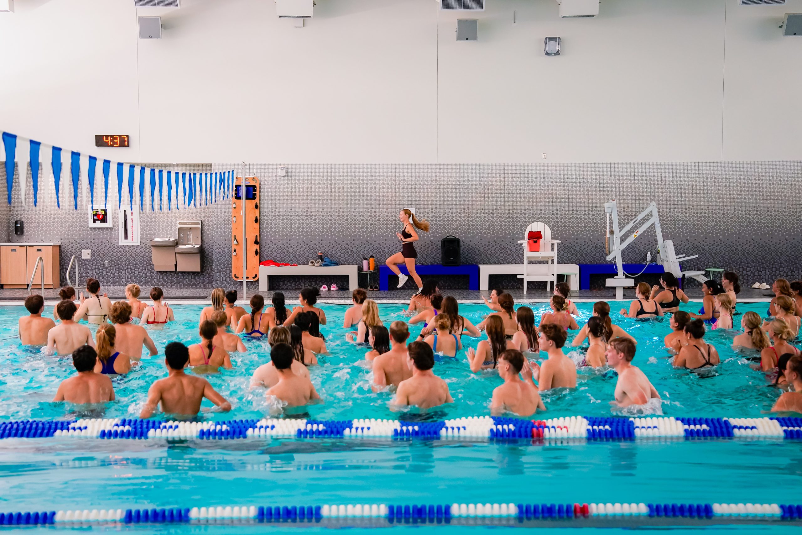 Participants are pictured in the Nick pool following a Group Fitness instructor.