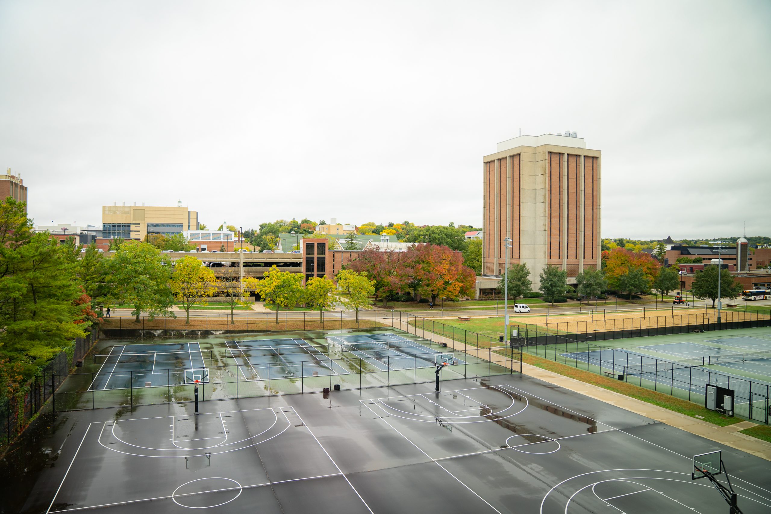 A photo that is an aerial view of basketball courts on a rainy day.
