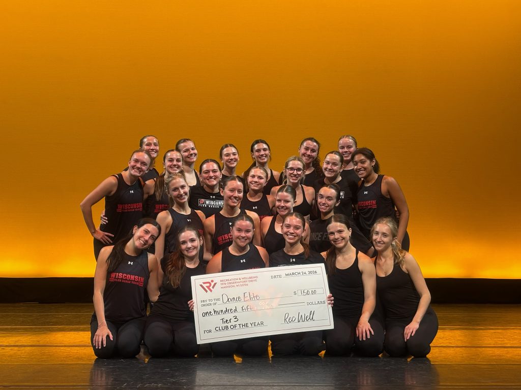 Members of the Dance Elite sport club smiling and holding their award.