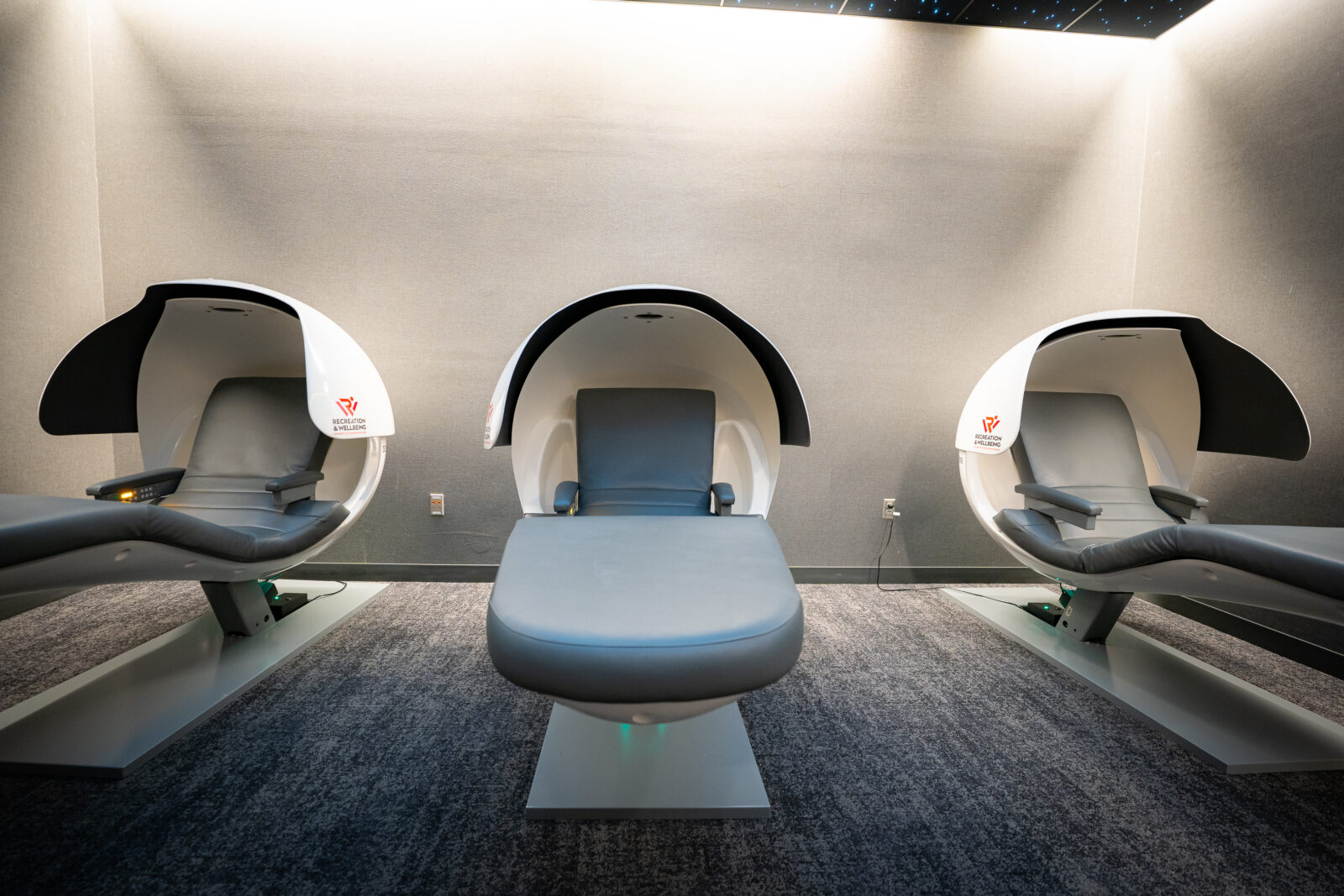 Three nap pods open and in a room.