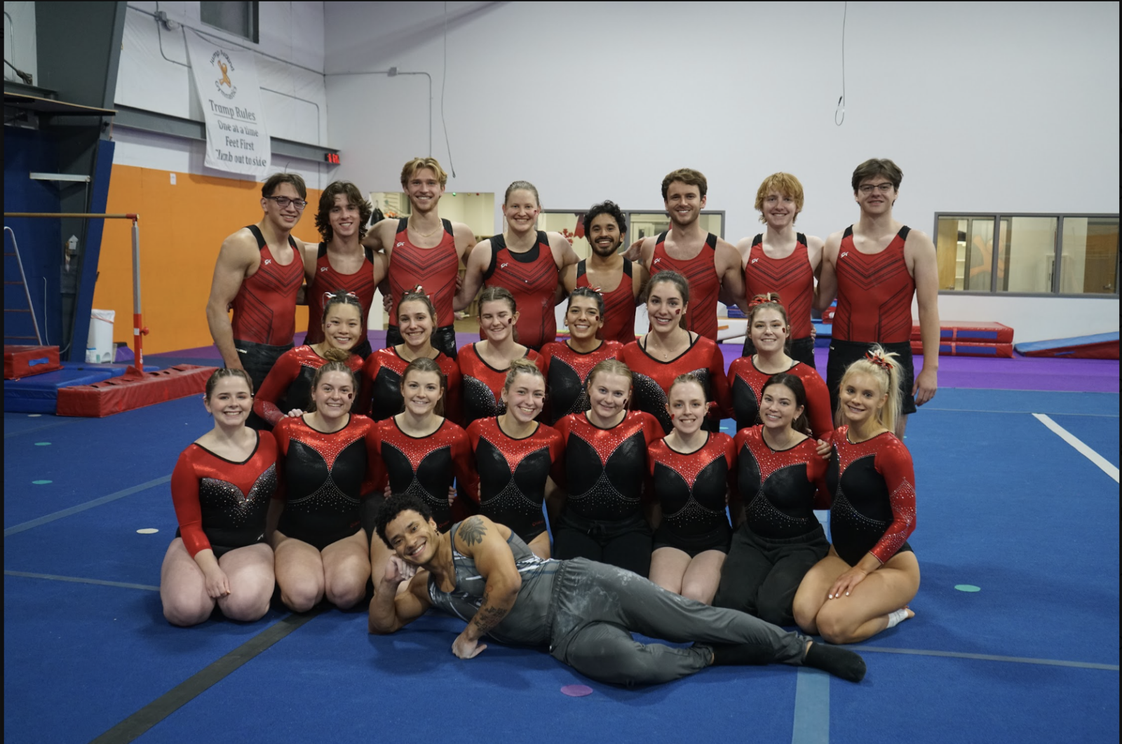 A photo of the Gymnastics team on a floor mat.