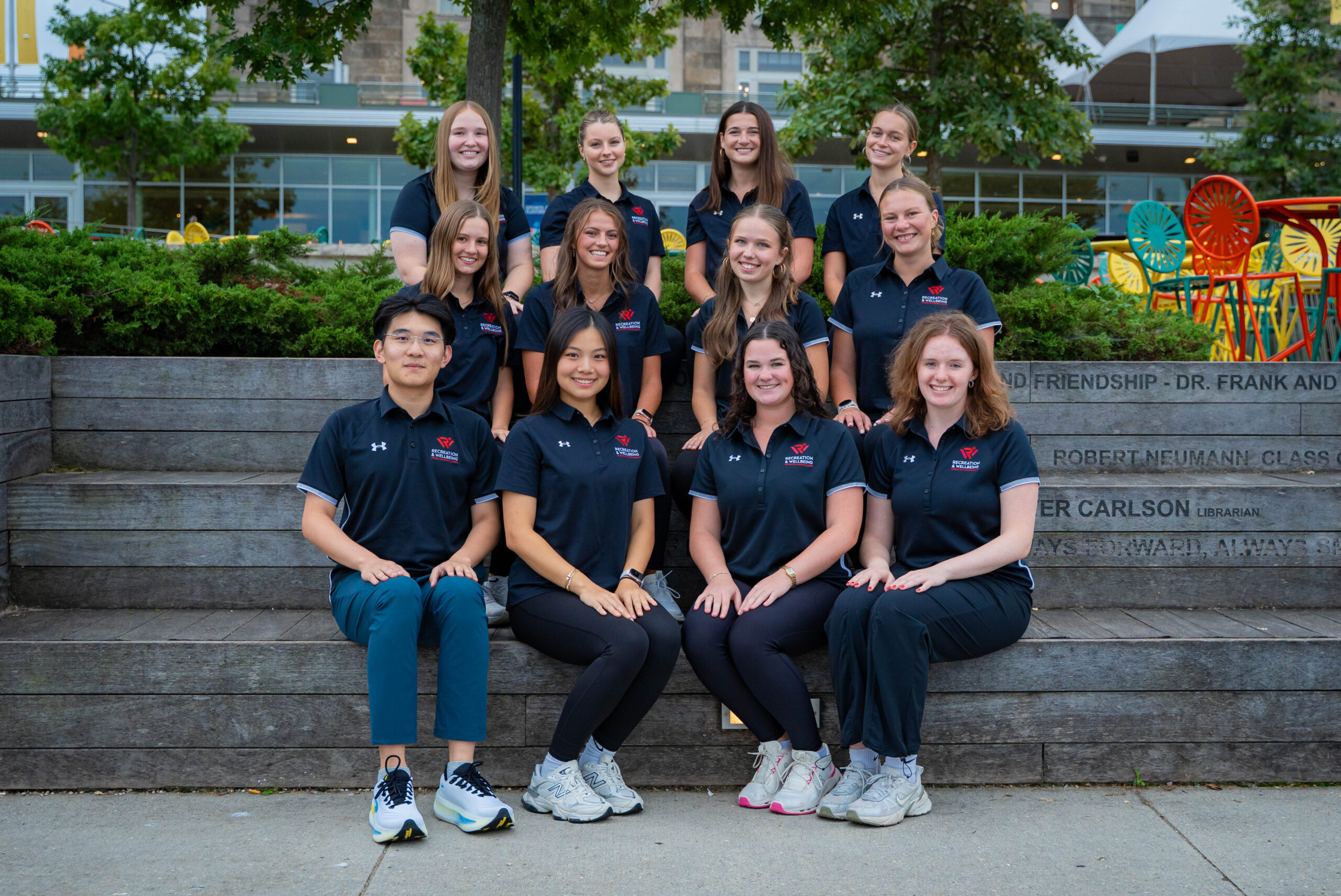 Wellbeing instructors pose for a photo on the stairs at Memorial Union.